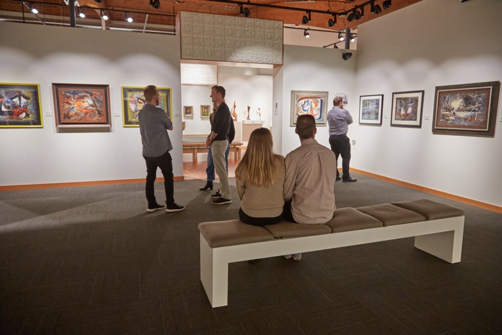 Visitors exploring a free Cascadia Art Museum exhibition