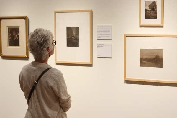 Visitor viewing works by Pacific Northwest artists